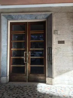 an entrance to a building with a wooden door at San Giovanni Apartment in Rome