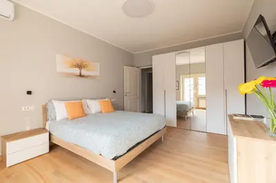 a bedroom with a bed and a vase of flowers at Marisa Home in Rome