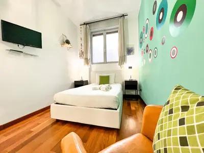 a bedroom with a bed and a tv and a couch at UNIQUE House - 3 Bedrooms & 2 Bathrooms with 4 Beds - 100 meters to the Metro A in Rome