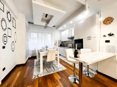 a kitchen and dining room with a table and chairs at UNIQUE House - 3 Bedrooms & 2 Bathrooms with 4 Beds - 100 meters to the Metro A in Rome