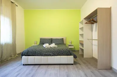 a bedroom with a bed and a green wall at Garden House by BuddyRent in Rome