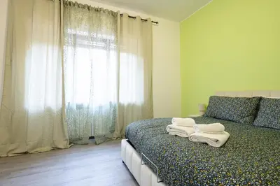 a bedroom with a bed with towels on it at Garden House by BuddyRent in Rome