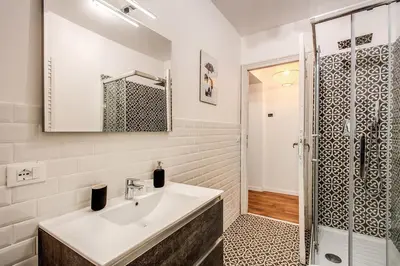 a bathroom with a sink and a shower at MONTI QUIET AND SPACIOUS APARTMENT in Rome