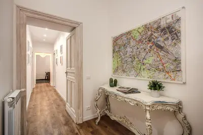 a hallway with a console table and a painting on the wall at MONTI QUIET AND SPACIOUS APARTMENT in Rome