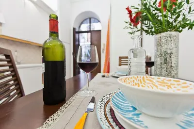 a bottle of wine and a glass on a table at Gianicolo Holiday House in Rome