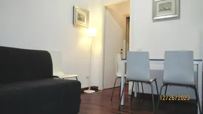a living room with a table and two chairs at Vatican Apartment in Rome