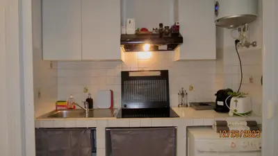 a small kitchen with a sink and a microwave at Vatican Apartment in Rome