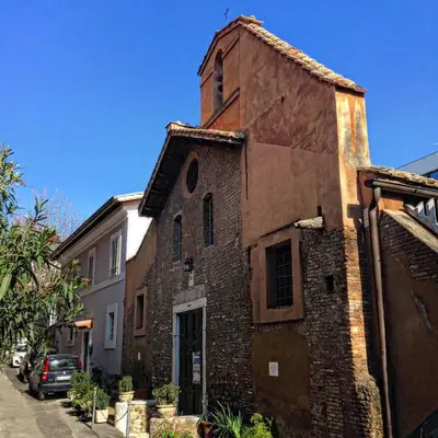 an old brick building with a tower on a street at Vatican Apartment in Rome