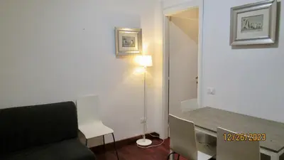 a living room with a couch and a table and a lamp at Vatican Apartment in Rome