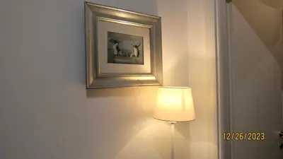 a lamp in a room with a picture on the wall at Vatican Apartment in Rome