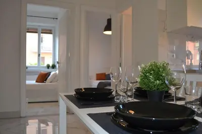 a living room with a table with wine glasses at Maison Coco' in Rome in Rome