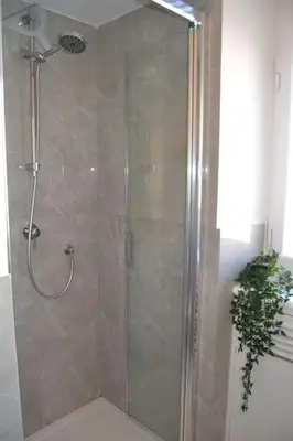 a shower with a glass door in a bathroom at Maison Coco' in Rome in Rome