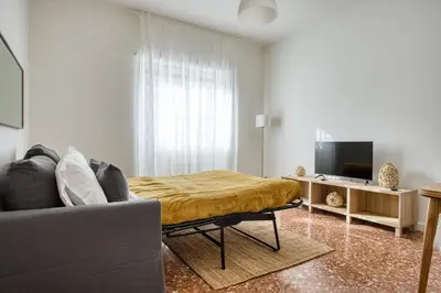 a living room with a couch and a television at Charme Apartment In Balduina by RHR in Rome