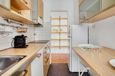 a kitchen with a white refrigerator and wooden counters at Charme Apartment In Balduina by RHR in Rome