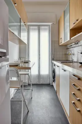 a kitchen with a sink and a table with a dishwasher at Charme Apartment In Balduina by RHR in Rome
