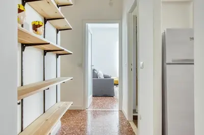 a kitchen with wooden shelves and a refrigerator at Charme Apartment In Balduina by RHR in Rome