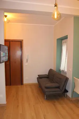 a living room with a couch and a television at Monolocale Urban House Marconi in Rome