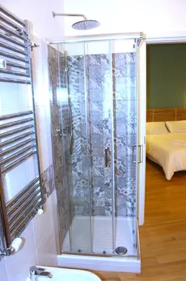 a shower with a glass door in a bathroom at Monolocale Urban House Marconi in Rome