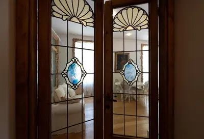 a glass door with a view of a room at ART ATELIER VITELLESCHI in Rome