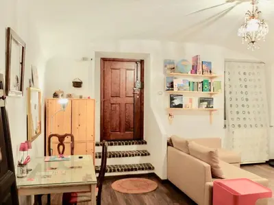 a living room with a couch and a table and a door at Vintage in Trastevere in Rome
