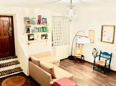a living room with a couch and a chair at Vintage in Trastevere in Rome