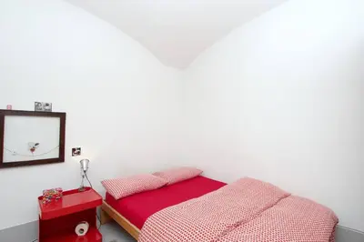 a bedroom with a bed and a mirror on the wall at Vintage in Trastevere in Rome