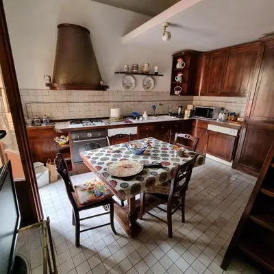 a kitchen with a table with chairs and a stove at Casa Nicoletta in Rome