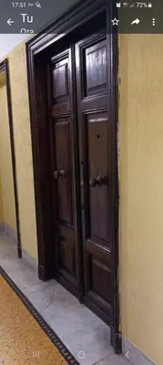 a pair of wooden doors in a hallway at Guest House Biondi Cavour in Rome