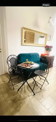 a living room with a couch and a table and chairs at Guest House Biondi Cavour in Rome