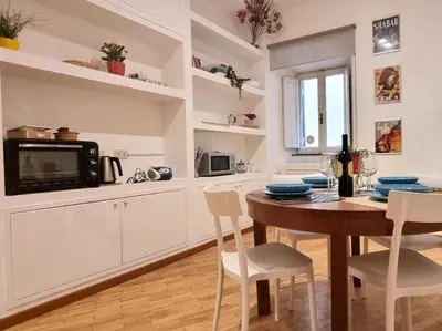 a kitchen and dining room with a table and chairs at Zaira's House - Largo Argentina Campo de’ fiori in Rome