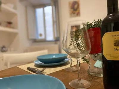 a table with two wine glasses and a bottle of wine at Zaira's House - Largo Argentina Campo de’ fiori in Rome