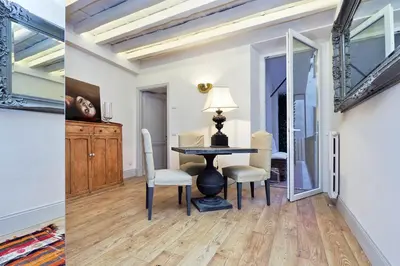 a dining room and living room with a table and chairs at Luxury Charme between Pantheon and Spanish Steps in Rome
