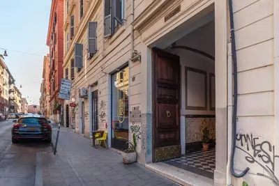 a car parked on a street next to a building at GuestHost - The secret garden of Rome! Apt x2 in Rome