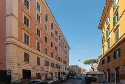 a city street with two tall buildings and cars at GuestHost - The secret garden of Rome! Apt x2 in Rome