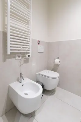 a white bathroom with a sink and a toilet at Trastevere Andrea' s home in Rome