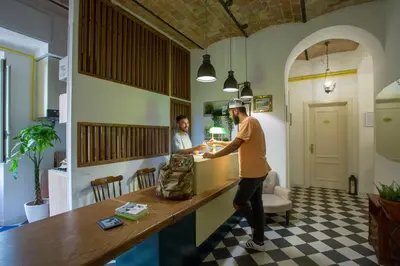 two men standing at a counter in a room at Hotel Cathrine in Rome