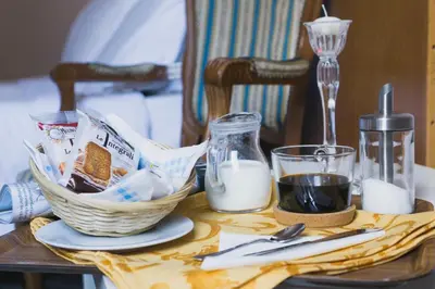 a table with a basket of food and milk on it at Hotel Cathrine in Rome