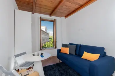 a living room with a blue couch and a table at Panoramic Flat Barberini in Rome