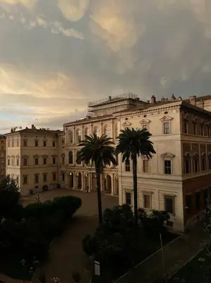 a large building with palm trees in front of it at Panoramic Flat Barberini in Rome