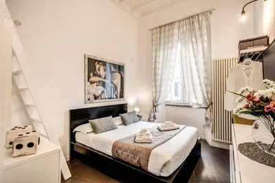a bedroom with a bed in a room at Trastevere Miracle Suite in Rome