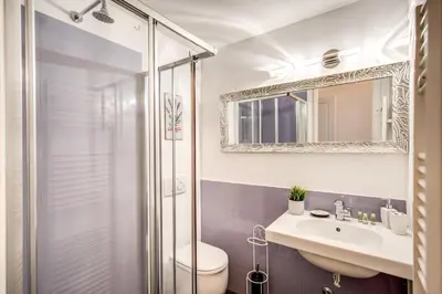a bathroom with a shower and a toilet and a sink at Trastevere Miracle Suite in Rome