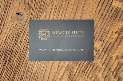 a black card sitting on top of a wooden table at Trastevere Miracle Suite in Rome
