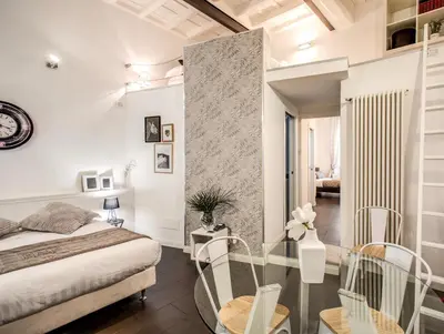 a bedroom with a bed and a glass table and chairs at Trastevere Miracle Suite in Rome