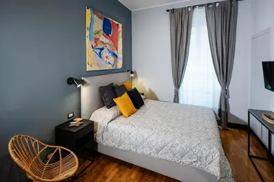 a bedroom with a bed with yellow pillows and a window at Tolemaide Orange Apartment in Rome