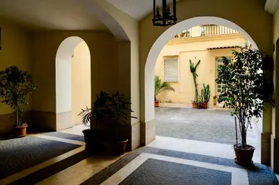 an empty hallway with potted plants in a building at Tolemaide Orange Apartment in Rome