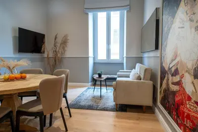 a living room with a table and a dining room at ROME City Center Apartment II in Rome
