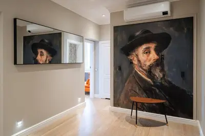 a painting of a man with a hat on a wall at ROME City Center Apartment II in Rome