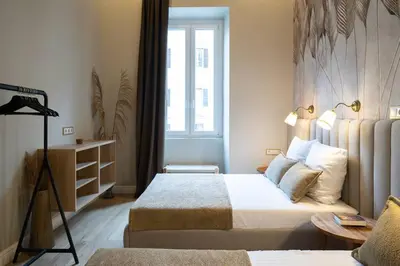a hotel room with two beds and a window at ROME City Center Apartment II in Rome