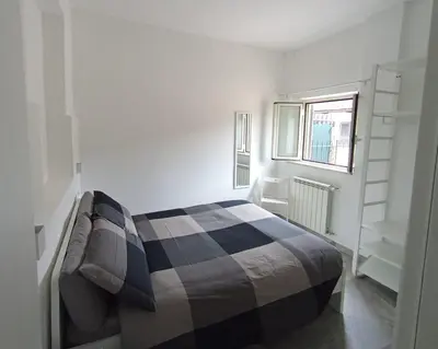 a bedroom with a bed and a window at A casa di Elly 2 in Rome