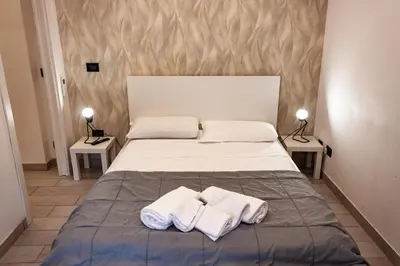 a bedroom with a bed with two towels on it at Domus Marconi Roma in Rome